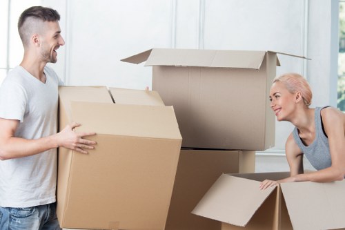 Professional movers handling home relocation items in Lowermorden