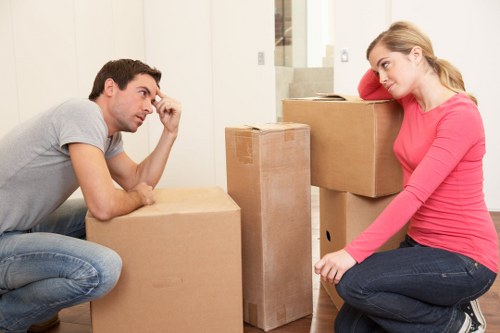 Professional movers organizing furniture during a Lowermorden relocation