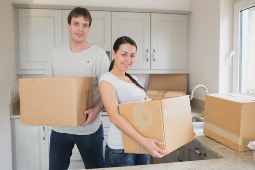 Removal team handling furniture for a Lowermorden home move
